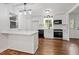 Bright kitchen with white cabinets, stainless steel appliances, and stylish lighting at 3907 Inwood Dr, Durham, NC 27705