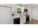 Bright kitchen features white cabinets, modern appliances, and a view of the outdoors from the window at 3907 Inwood Dr, Durham, NC 27705