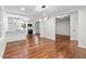Bright open-concept living room featuring newly refinished hardwood floors at 3907 Inwood Dr, Durham, NC 27705