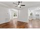 Bright living room with hardwood floors, a ceiling fan, and easy access to the kitchen at 3907 Inwood Dr, Durham, NC 27705