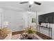 Bright living room with hardwood floors, a comfortable sofa, stylish decor, and an open doorway to the backyard at 3907 Inwood Dr, Durham, NC 27705