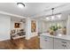 Open-concept living space showcasing hardwood floors, a stylish kitchen island, and seamless flow to the living room at 3907 Inwood Dr, Durham, NC 27705
