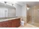 Bathroom with double vanity, granite countertops, and a glass shower with light tile at 400 W North St # 1430, Raleigh, NC 27603