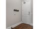 Clean entryway with hardwood floors, grey wall and wall mounted coat rack at 400 W North St # 1430, Raleigh, NC 27603