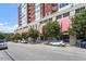 Modern high-rise building featuring covered storefronts and tree-lined street at 400 W North St # 1430, Raleigh, NC 27603