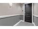 Condo hallway with a gray-toned walls, carpet, and a black door at 400 W North St # 1430, Raleigh, NC 27603