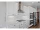 Elegant kitchen featuring white cabinets, marble countertops, and stainless steel appliances at 400 W North St # 1430, Raleigh, NC 27603