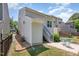 The home's backyard features a grassy lawn, a patio, and a staircase leading to an upper level at 420 Cherry St, Fuquay Varina, NC 27526