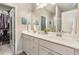Bright bathroom with double sinks, white cabinets, and a walk-in closet at 420 Cherry St, Fuquay Varina, NC 27526