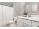 Bathroom with a white vanity, a framed mirror, and a shower with a white curtain at 420 Cherry St, Fuquay Varina, NC 27526