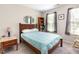 Cozy bedroom with a bed, a bookshelf, a side table, and a window, offering a comfortable and functional space at 420 Cherry St, Fuquay Varina, NC 27526