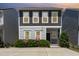 Charming two-story home with blooming flowers, a welcoming front porch and neutral-colored siding at 420 Cherry St, Fuquay Varina, NC 27526