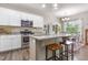 Bright kitchen with white cabinets, stainless steel appliances, granite countertops, and an island with a dining area at 420 Cherry St, Fuquay Varina, NC 27526