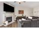 Inviting living room with a fireplace, a large flat-screen TV, comfortable sofas, and stylish decor for relaxation at 420 Cherry St, Fuquay Varina, NC 27526