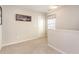 Neutral-toned loft space with a window, a neutral carpet, and a framed photo on the wall at 420 Cherry St, Fuquay Varina, NC 27526