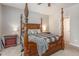 Main bedroom with a four-poster bed, a ceiling fan, and matching bedside tables at 420 Cherry St, Fuquay Varina, NC 27526
