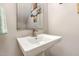 Clean and simple powder room with a modern vanity and a decorative mirror at 420 Cherry St, Fuquay Varina, NC 27526