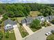 Bird's-eye view of homes nestled among mature trees, showcasing manicured lawns at 4805 Ayden Mill Rd, Apex, NC 27539