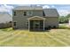 The backyard is a large green lawn, complemented by a screened porch attached to the house at 4805 Ayden Mill Rd, Apex, NC 27539