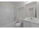 Clean, well-lit bathroom with a shower-tub combo, white toilet, vanity, and a large mirror at 4805 Ayden Mill Rd, Apex, NC 27539