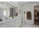 Bright bathroom featuring double sinks, a toilet, a walk-in shower, and well-placed decorative towels and plants at 4805 Ayden Mill Rd, Apex, NC 27539