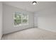 Inviting bedroom boasts a large window overlooking lush greenery and an attached bath area at 4805 Ayden Mill Rd, Apex, NC 27539