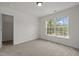 Cozy bedroom featuring a large window with view and an entrance to the closet at 4805 Ayden Mill Rd, Apex, NC 27539