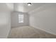 Clean bedroom features a vaulted ceiling, a single window, and neutral carpeting at 4805 Ayden Mill Rd, Apex, NC 27539