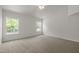 Spacious bedroom with neutral carpet and two large windows providing ample natural light at 4805 Ayden Mill Rd, Apex, NC 27539