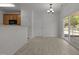 Dining area with sliding glass doors, modern light fixture, and kitchen access at 4805 Ayden Mill Rd, Apex, NC 27539