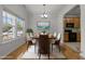 Bright dining room features hardwood floors, large windows, elegant lighting and access to an eat-in kitchen at 4805 Ayden Mill Rd, Apex, NC 27539