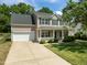 Charming two-story home with a well-manicured lawn and inviting front porch at 4805 Ayden Mill Rd, Apex, NC 27539