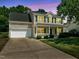 Charming two-story home with green shutters, covered porch, and well-maintained lawn at 4805 Ayden Mill Rd, Apex, NC 27539