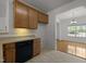Cozy kitchen showcasing wood cabinetry and a view into the dining area at 4805 Ayden Mill Rd, Apex, NC 27539