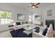 Well-lit living room with contemporary furniture and a sleek glass coffee table at 4805 Ayden Mill Rd, Apex, NC 27539