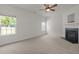 Neutral living area featuring a cozy fireplace, soft carpet, and bright windows at 4805 Ayden Mill Rd, Apex, NC 27539