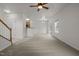 Spacious open-concept layout with staircase, carpet, and access to the kitchen at 4805 Ayden Mill Rd, Apex, NC 27539