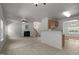 Open floor plan with living room, kitchen, dining area, and staircase at 4805 Ayden Mill Rd, Apex, NC 27539