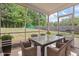 A screened-in porch with a table and seating offers an inviting spot to unwind outdoors at 4805 Ayden Mill Rd, Apex, NC 27539