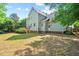 Green backyard featuring a raised wooden deck and lush landscaping, providing a peaceful outdoor space at 4900 American Dr, Durham, NC 27705