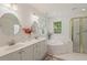 Bright bathroom with double vanity, garden tub, and glass-enclosed shower at 4900 American Dr, Durham, NC 27705