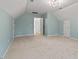 Bright bonus room with ample space, carpeting, and lots of storage at 4900 American Dr, Durham, NC 27705