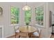 Sunny breakfast nook with a round table and chairs, bathed in natural light from surrounding windows at 4900 American Dr, Durham, NC 27705