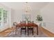 Elegant dining room with a wooden table, stylish chairs, and a modern chandelier at 4900 American Dr, Durham, NC 27705