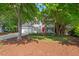 Charming home with a red door, manicured front yard, and mature trees, showcasing curb appeal at 4900 American Dr, Durham, NC 27705