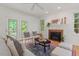 Inviting living room featuring a fireplace, stylish seating, and French doors to the outside at 4900 American Dr, Durham, NC 27705
