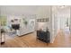 Spacious living room featuring a brick fireplace, hardwood floors, and a view into the kitchen at 4900 American Dr, Durham, NC 27705