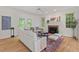 Cozy living room with a fireplace, neutral furnishings, and access to the outdoors at 4900 American Dr, Durham, NC 27705