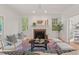 Cozy living area with fireplace, accent seating, and view of built-in bookshelves beyond the doorway at 4900 American Dr, Durham, NC 27705