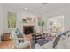 Bright living room with fireplace, windows, hardwood floors, and comfortable seating, perfect for entertaining at 4900 American Dr, Durham, NC 27705